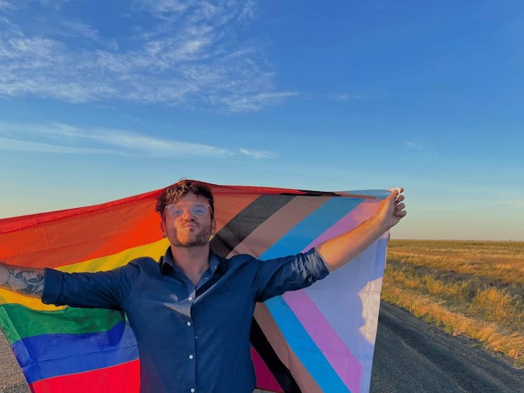 Rainbow on the Plains with progressive rainbow flag out on the plains