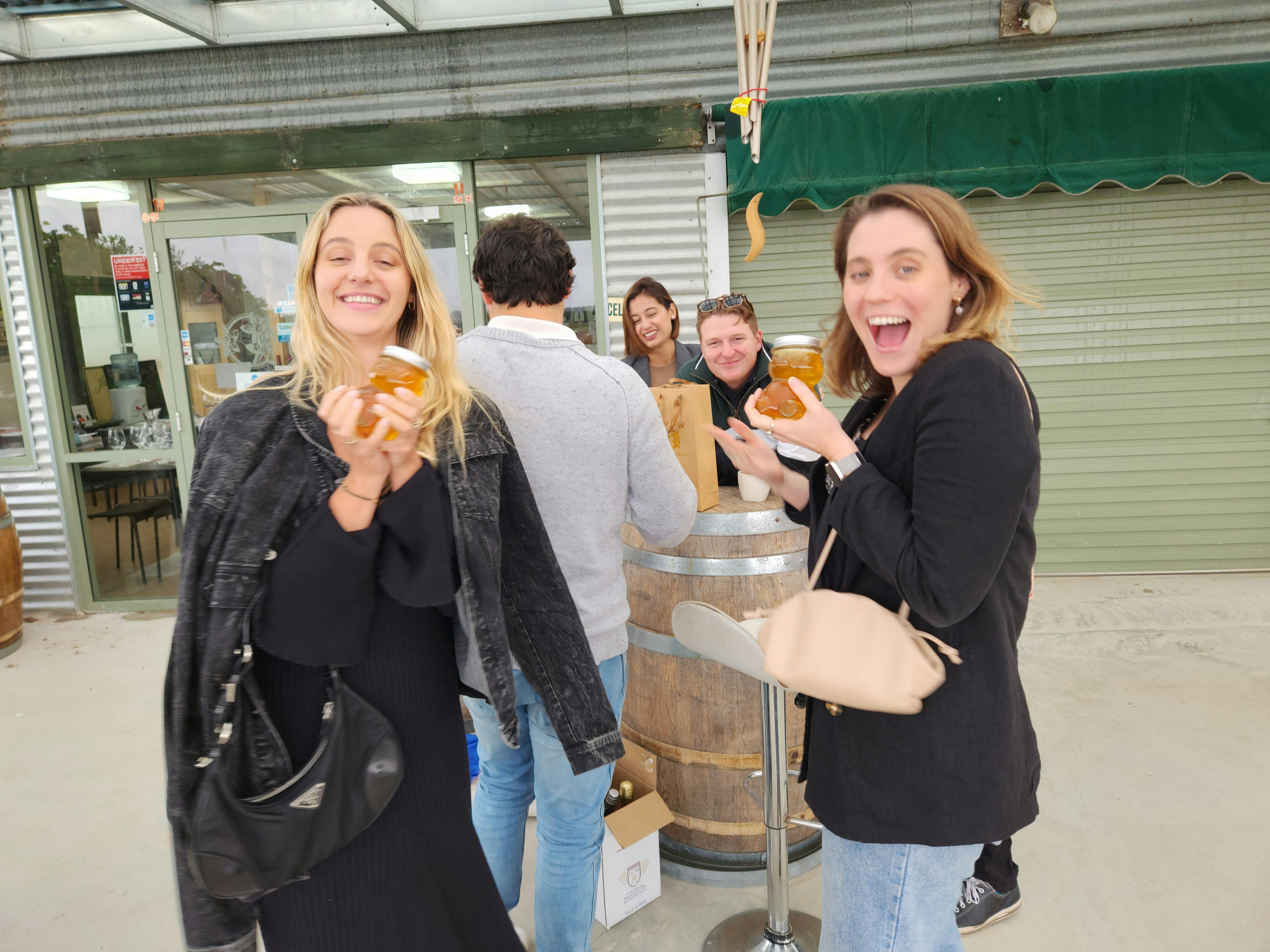 photo of two females holding honey
