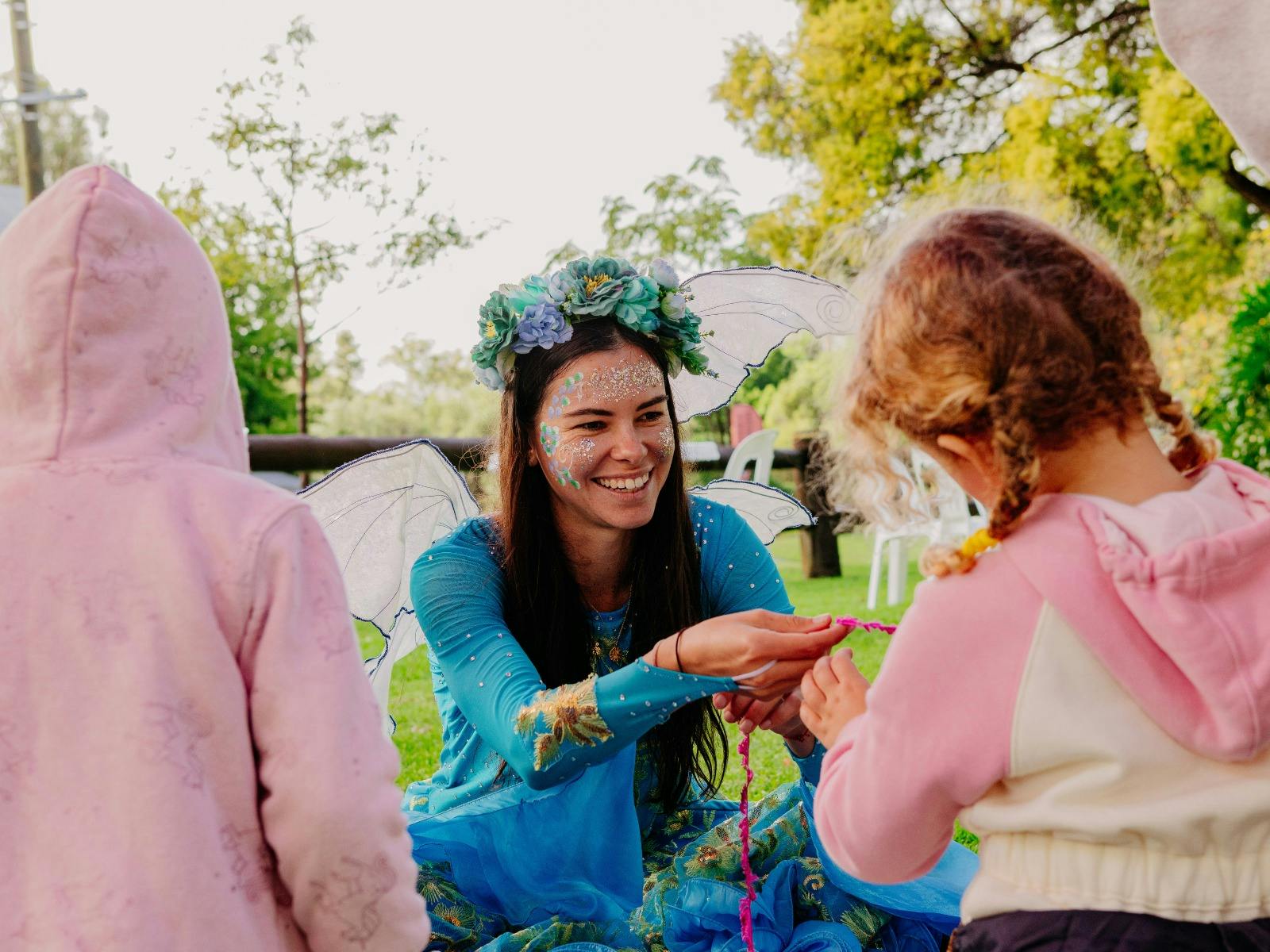 A fairy helping a child make their craft item
