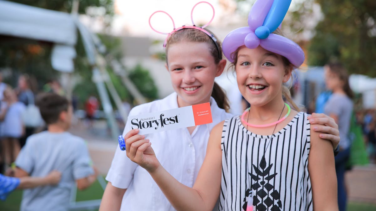 Two girls with balloon and bookmark