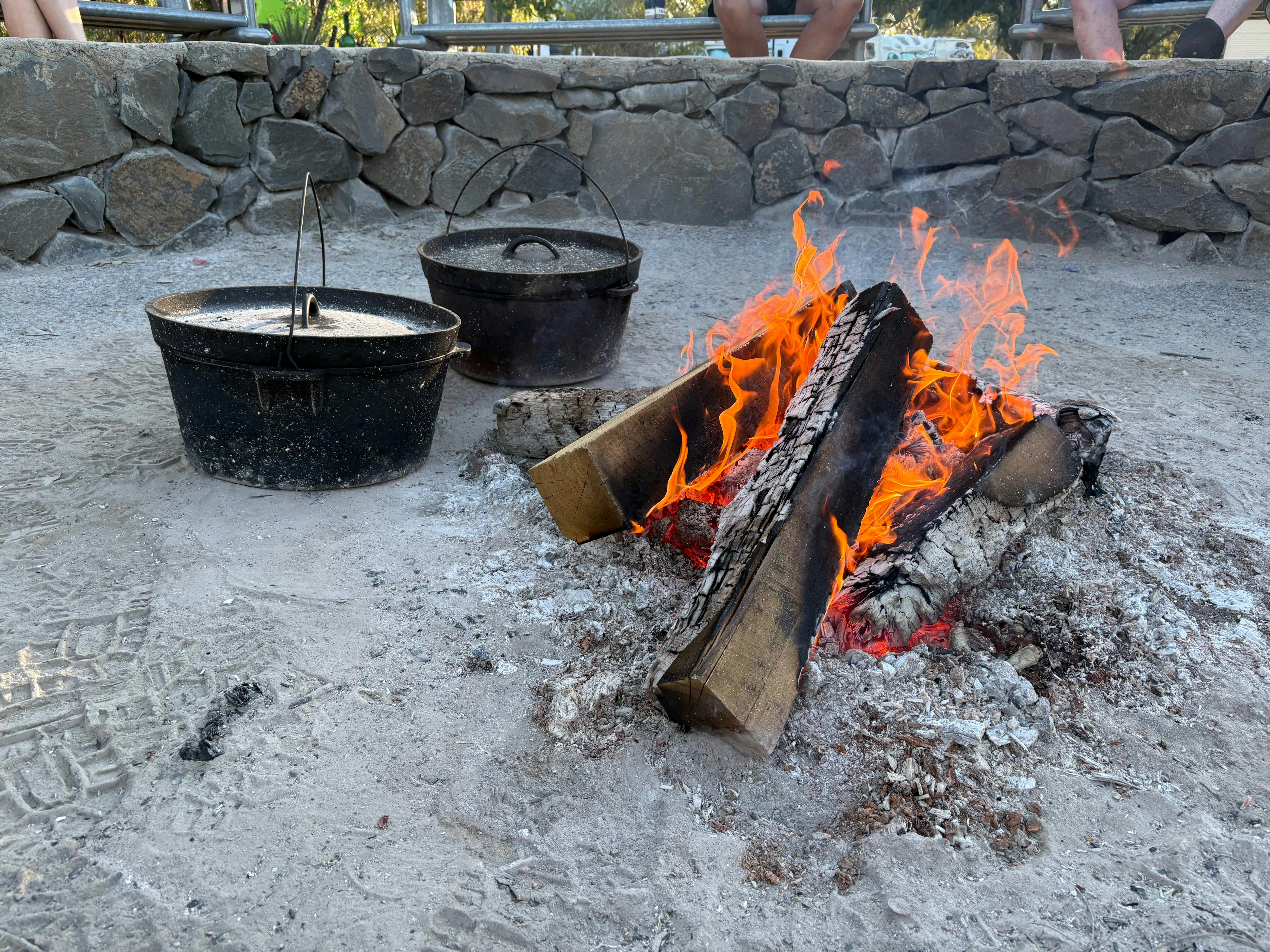 Major Mitchell Caravan Park camp oven dinner being cooked in the fire pit for guests