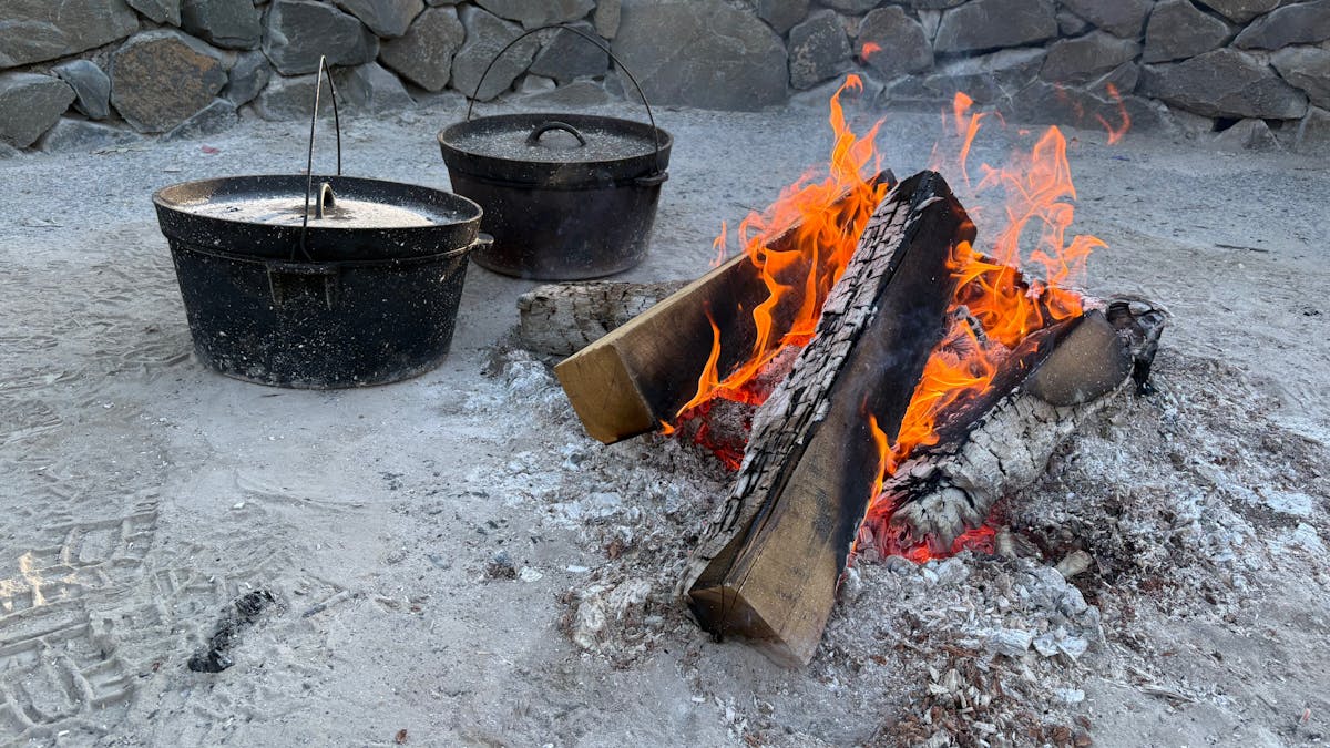 Major Mitchell Caravan Park camp oven dinner being cooked in the fire pit for guests