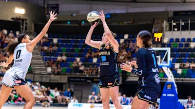 UC Capitals player about to shoot a basketball while a defender has their hand out.