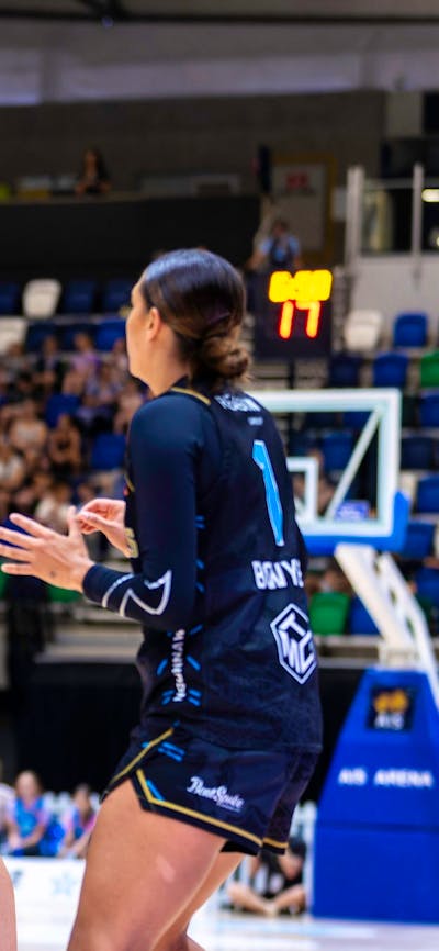 UC Capitals player about to shoot a basketball while a defender has their hand out.
