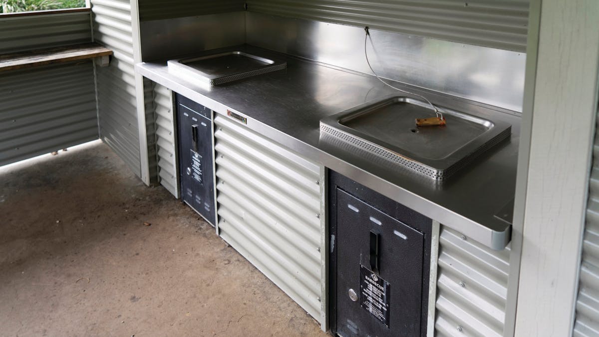 Two BBQs in cooking shelter.