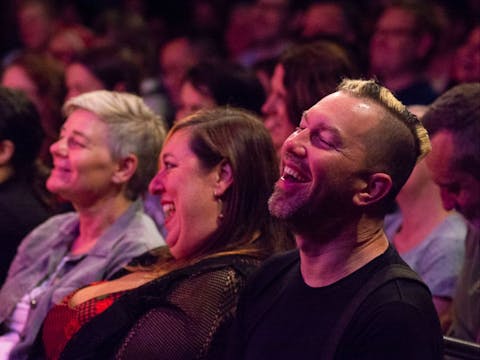 Close up of audience laughing