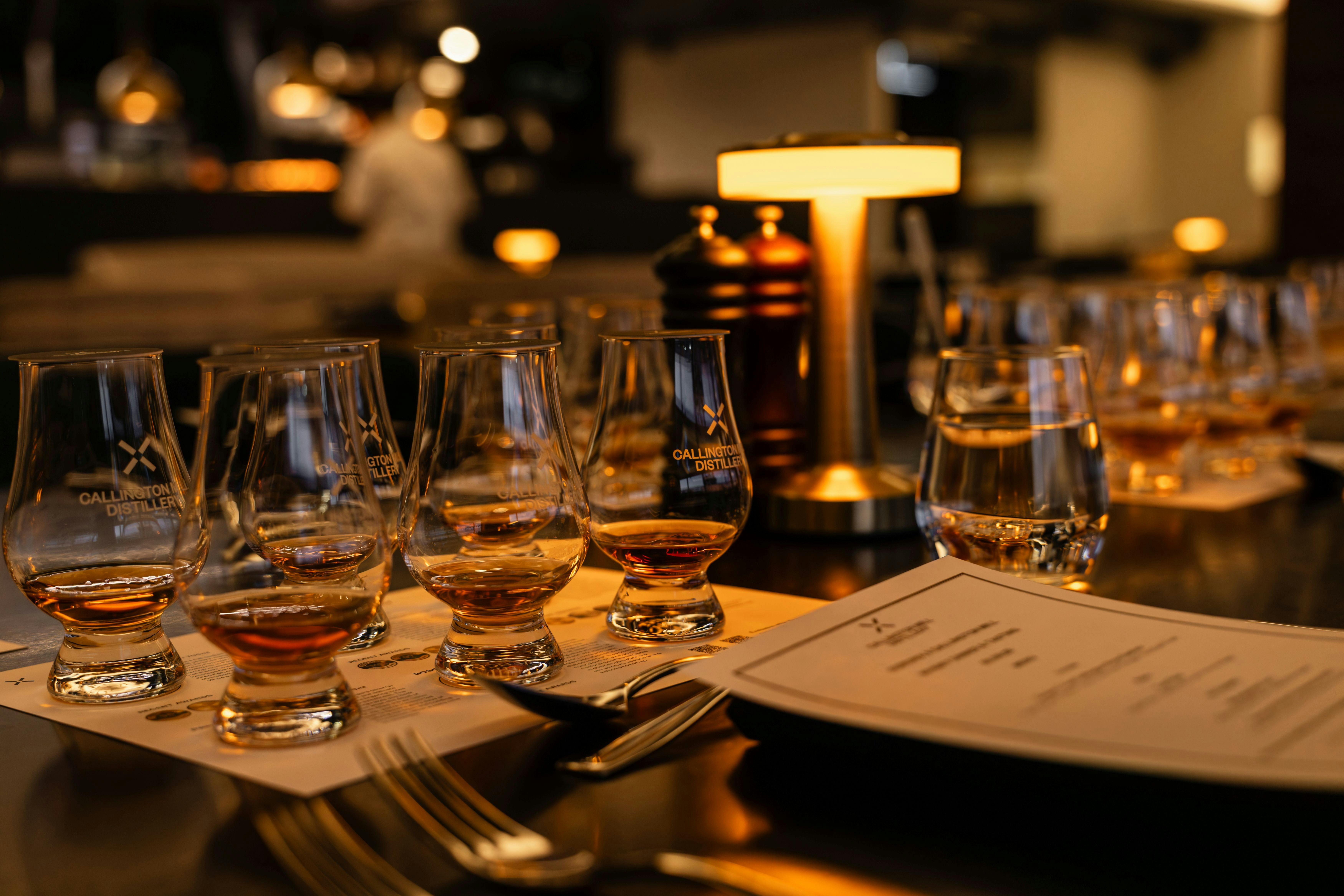 Whisky glasses and a lamp on a table