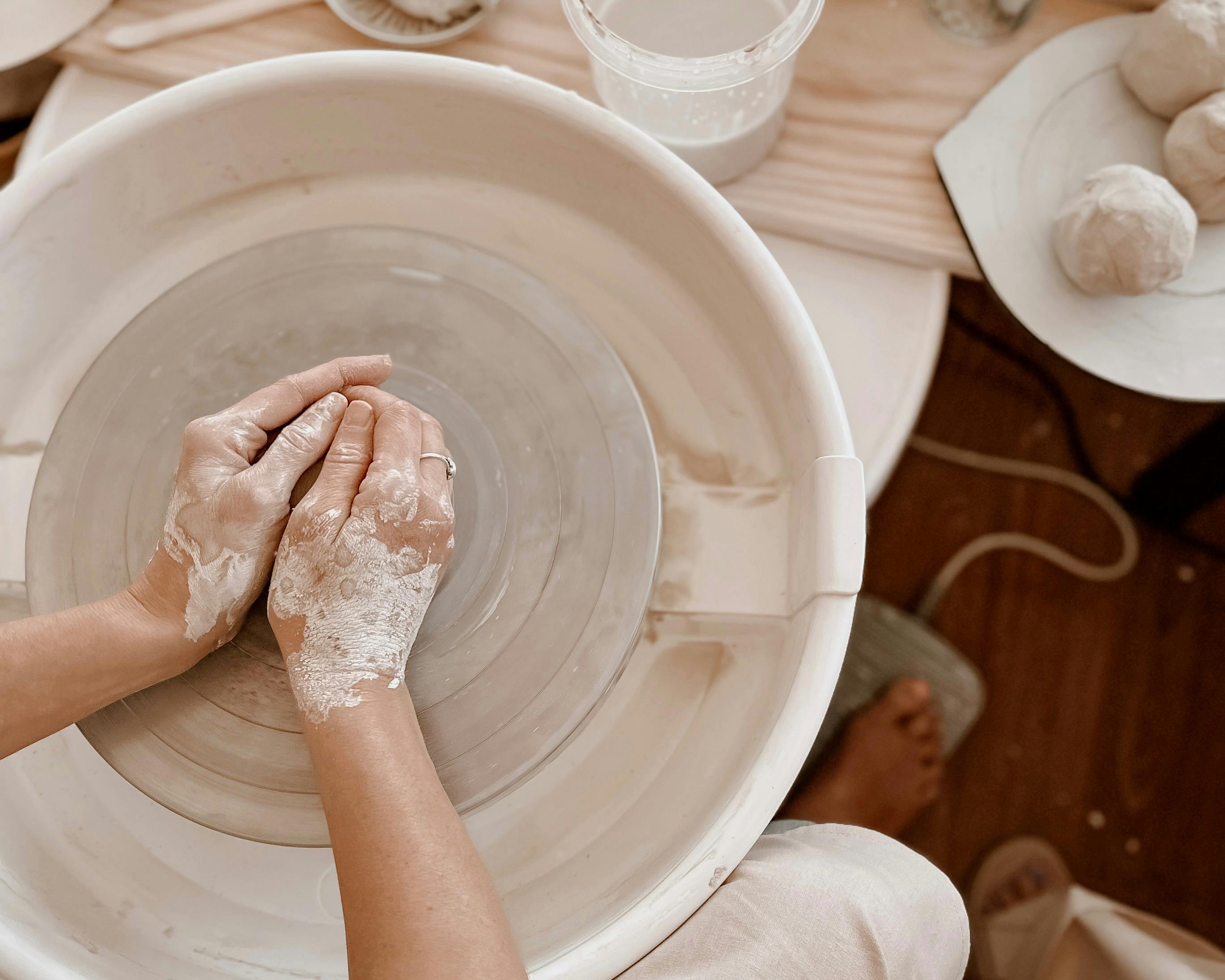 Woman wheel throwing