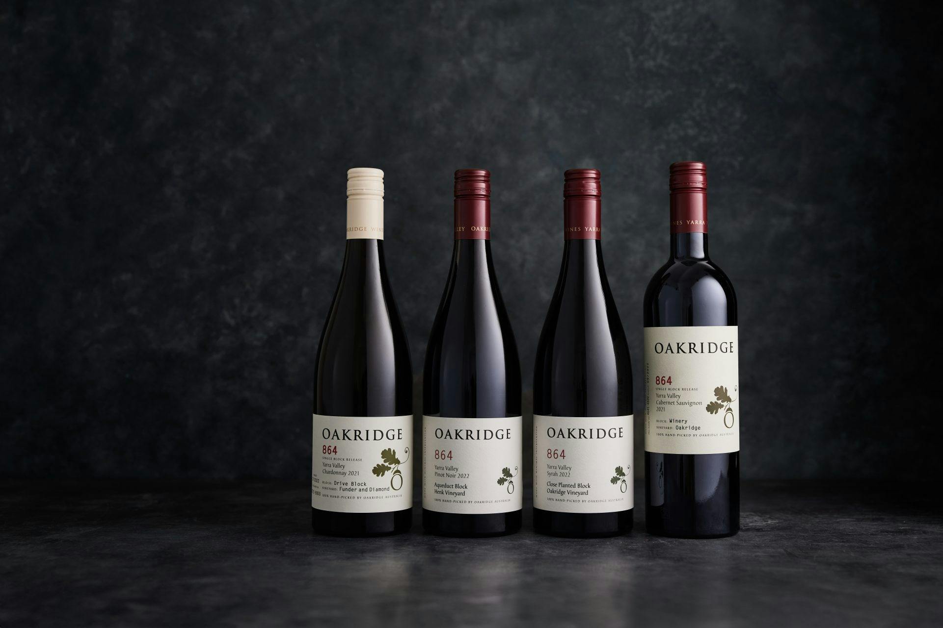 A collection of 4 bottles of Oakridge 864 Single Block Wines on a charcoal background
