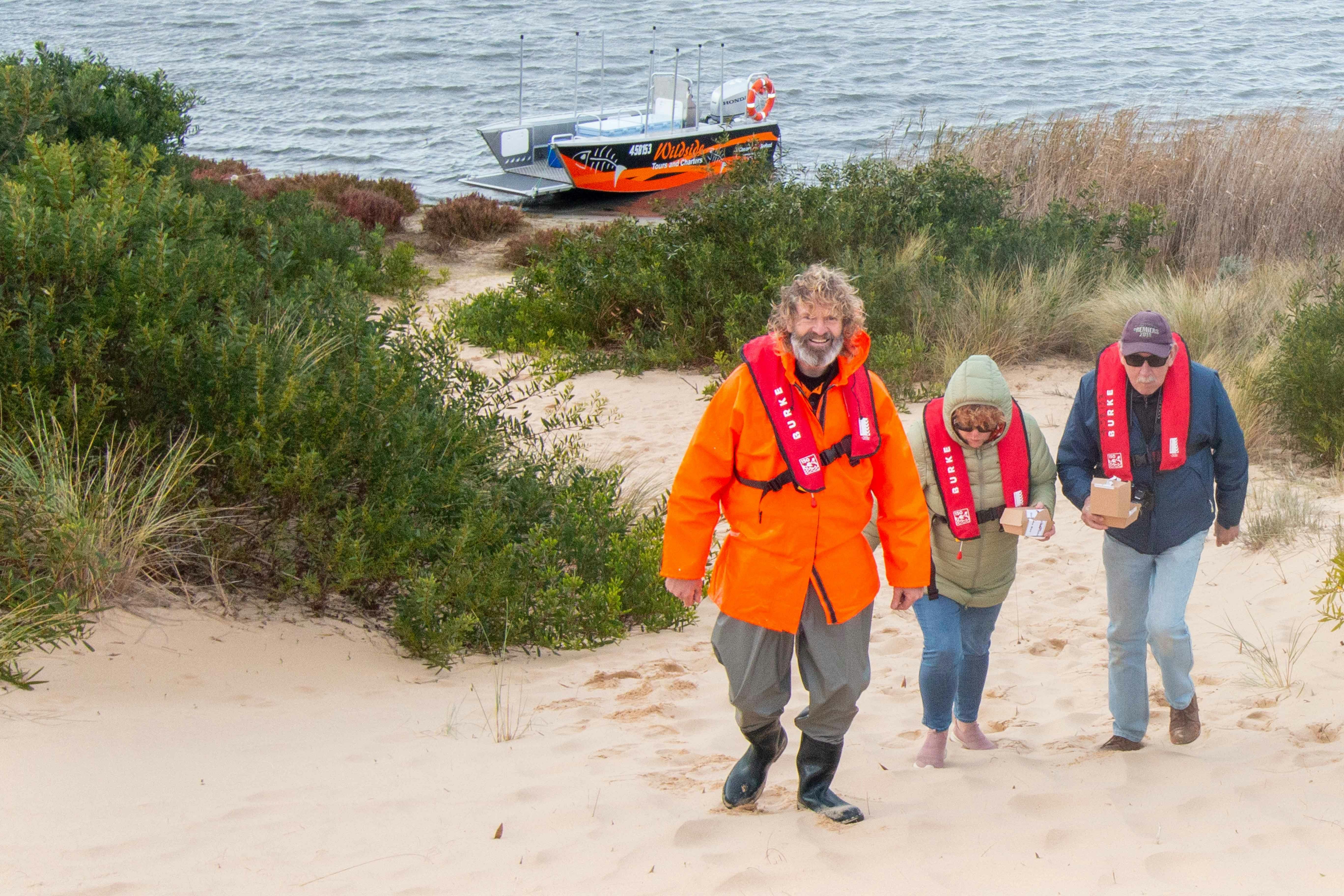 GLEN LEADING A TOUR GROUP UP A SANDHILL