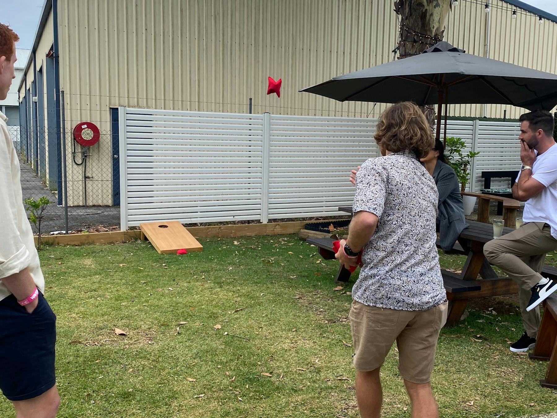A group playing Corn Hole at The Terrace PMQ. A Perfect game to enjoy with friends over a beer.