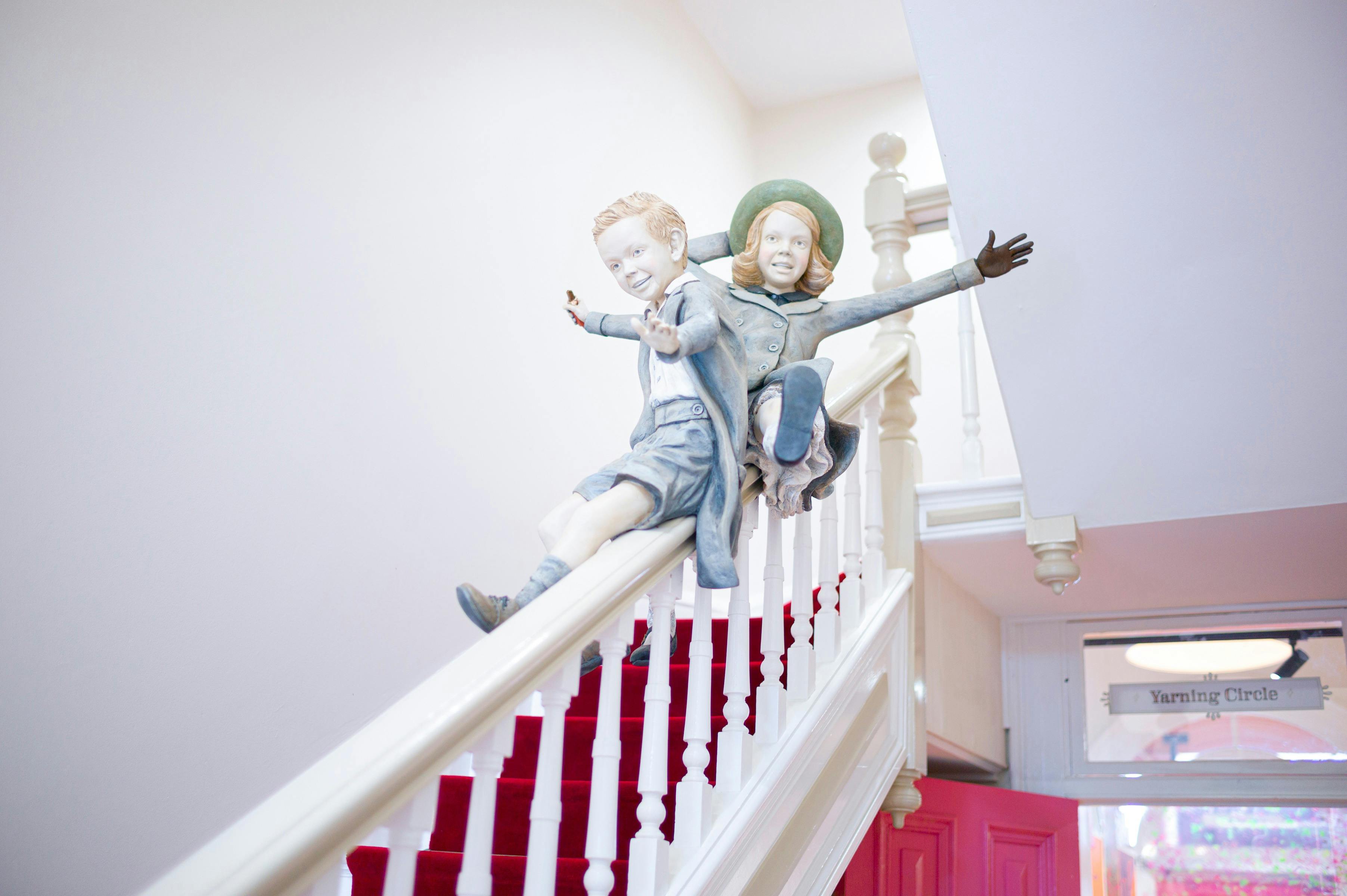 photo of models of two children sliding down bannister inside Storybank Maryborough