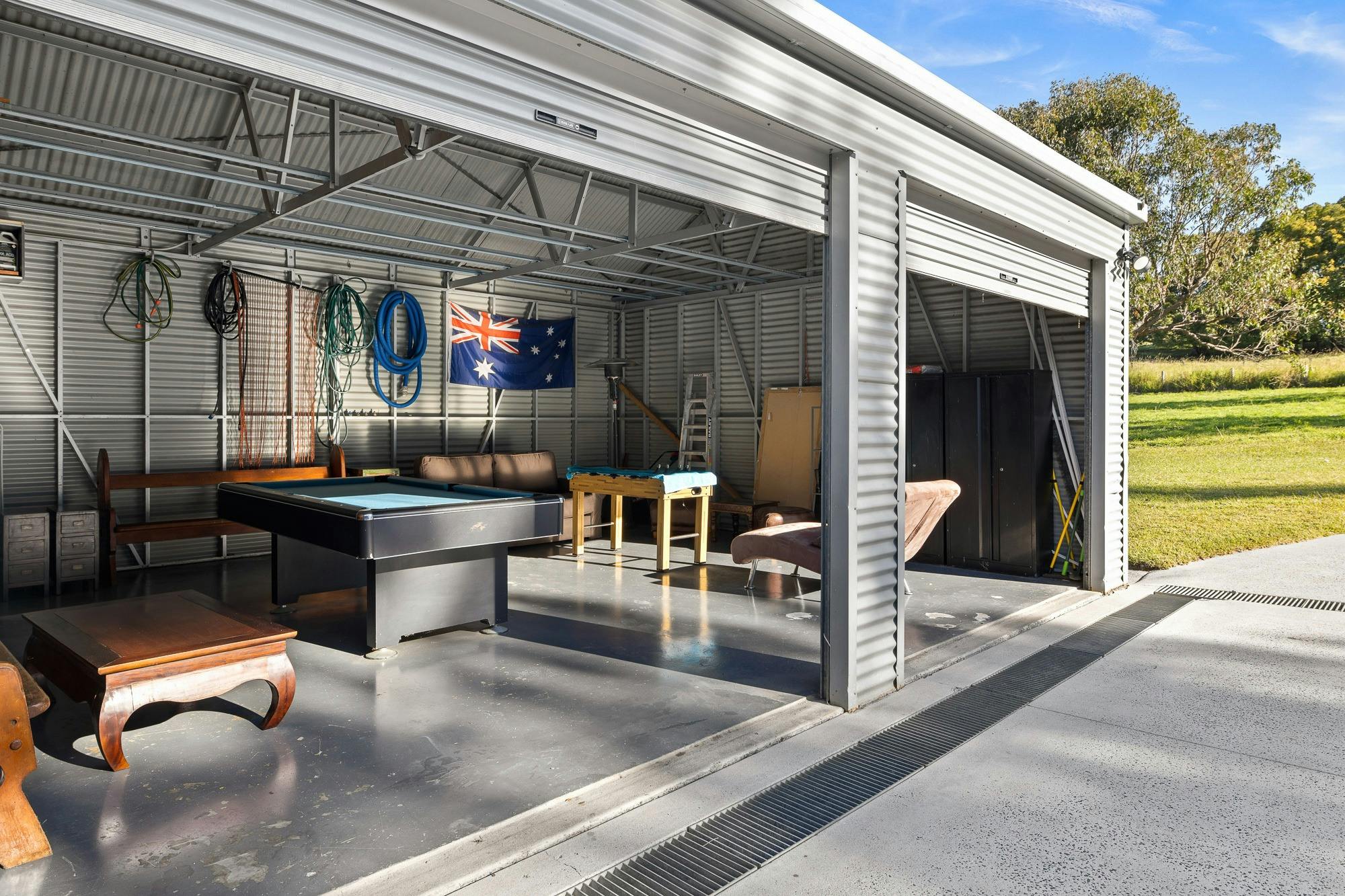 Garage with a billiard table, bar stools, and ample lighting for entertainment