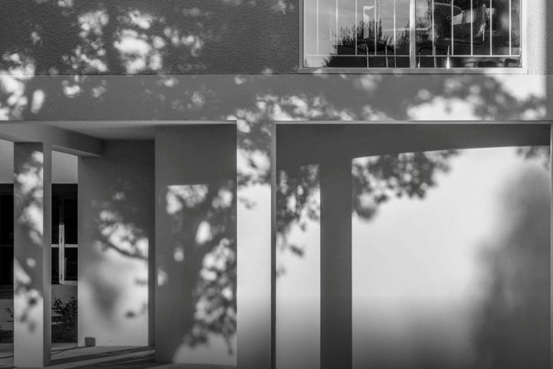 A black and white photograph of an architectural detail of a brutalist apartment building