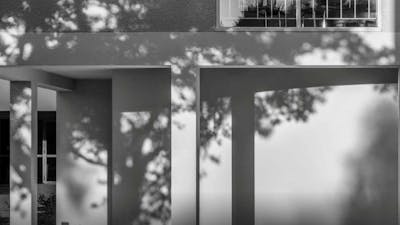 A black and white photograph of an architectural detail of a brutalist apartment building