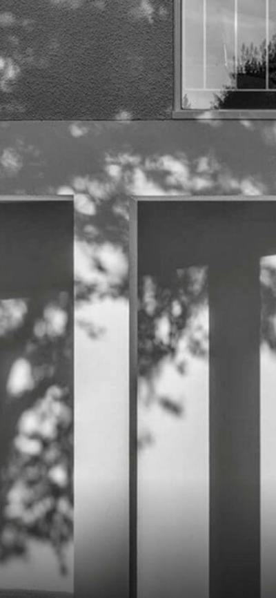 A black and white photograph of an architectural detail of a brutalist apartment building
