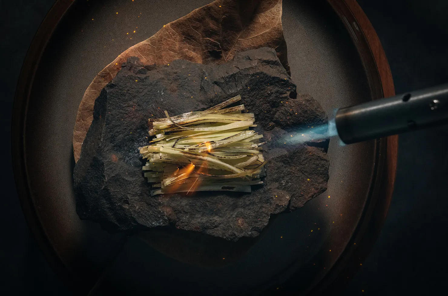 Wagyu and leek being blow torched and served smoking