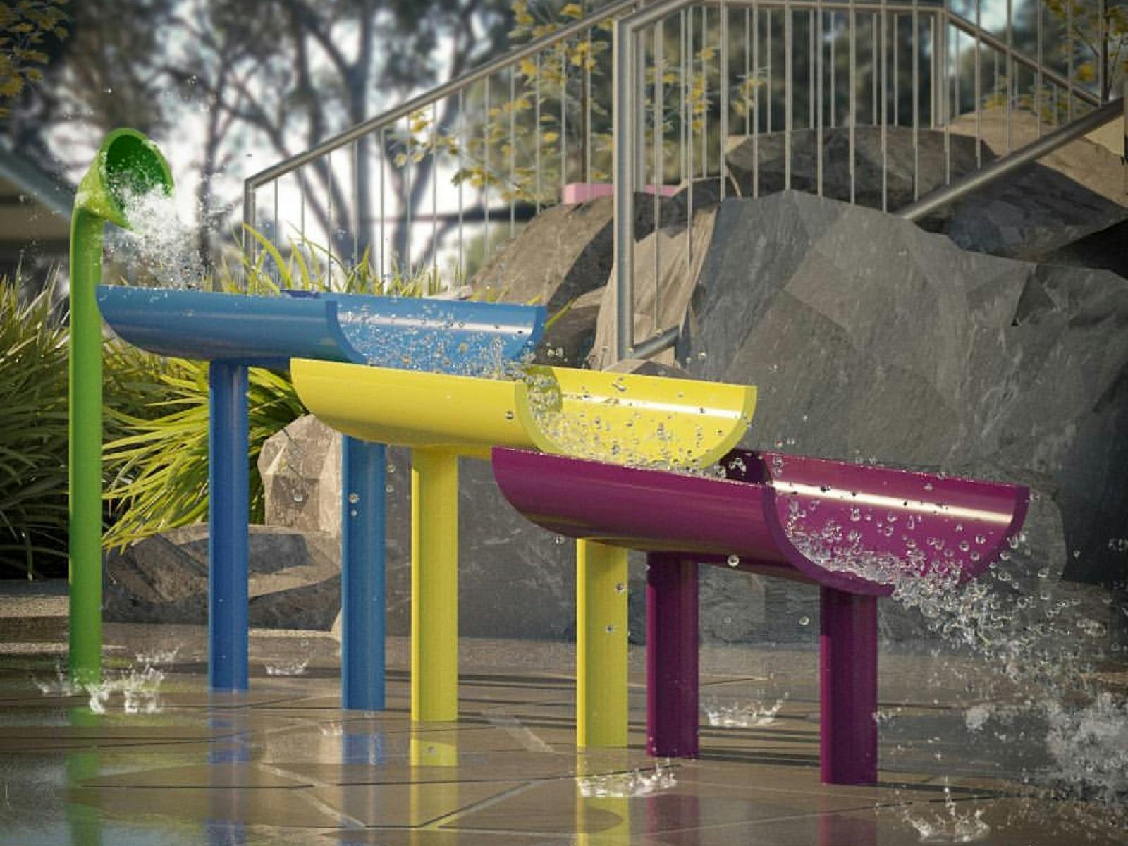 Water flowing like a waterfall down colourful splash park equipment.