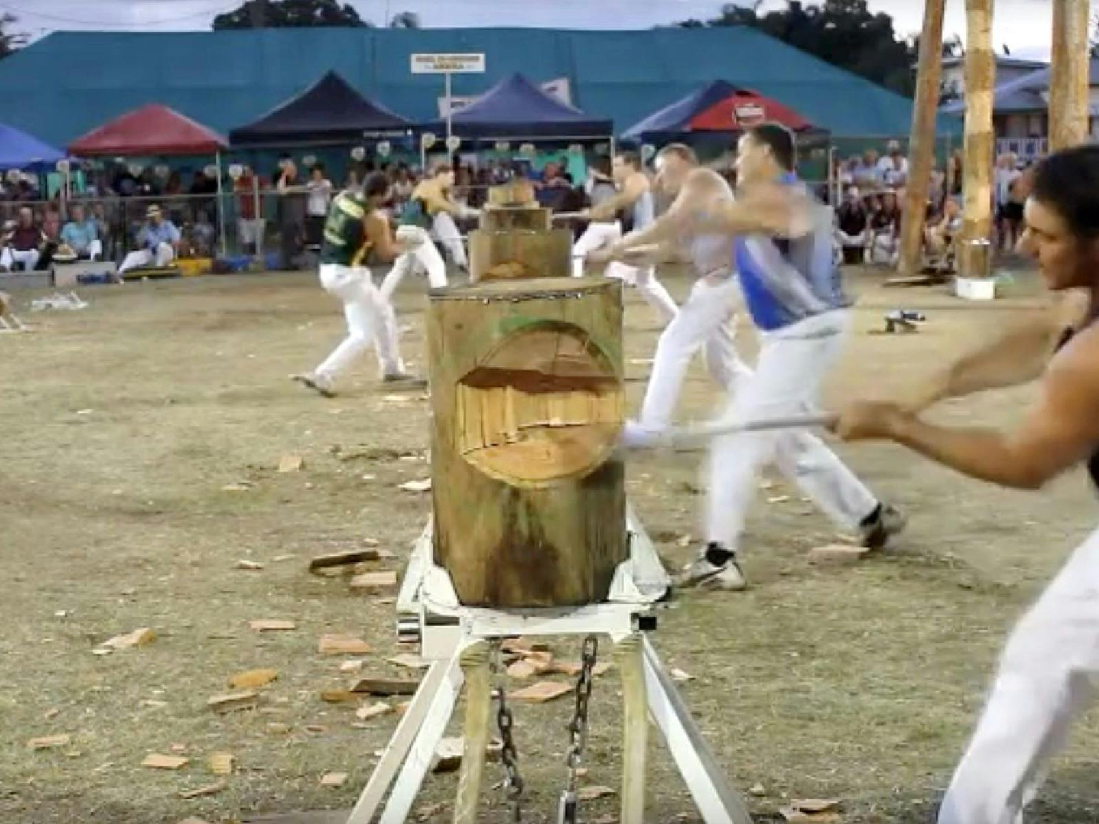 Men competing in woodchop comp