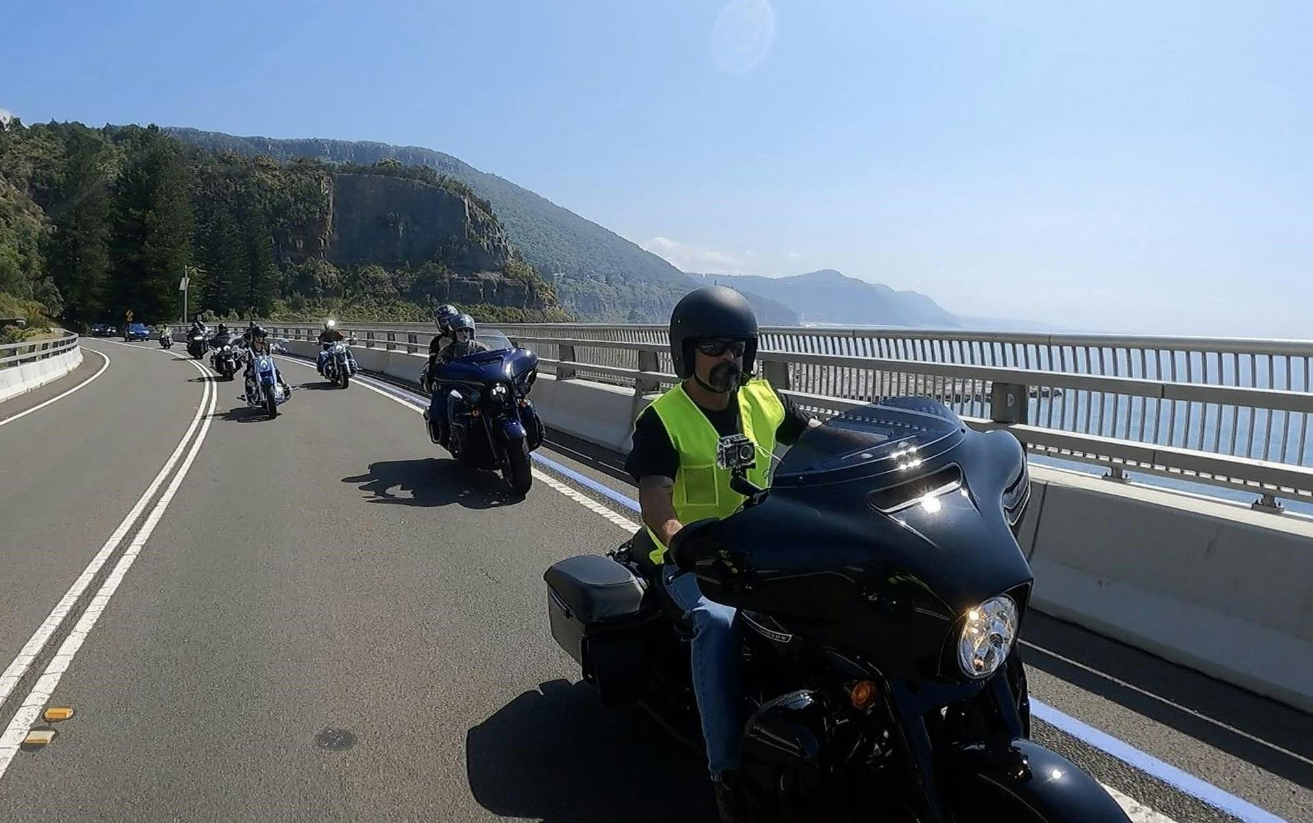 Motorcycles riding across Seacliff Bridge