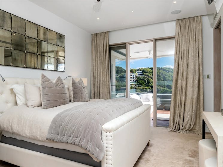 nviting master bedroom with a plush king-size bed and elegant furnishings
