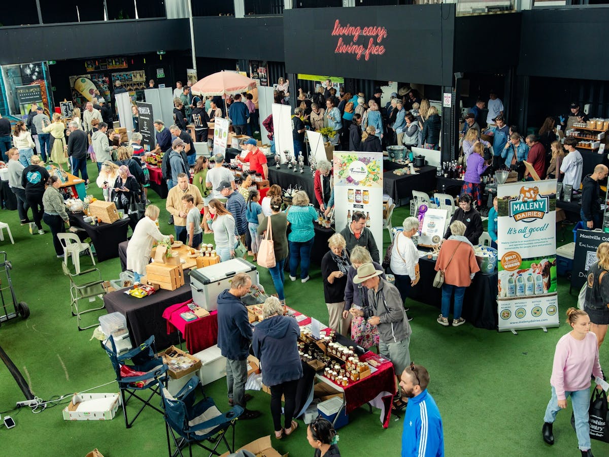 A wide show of the venue showing various producer stalls and guests wondering around