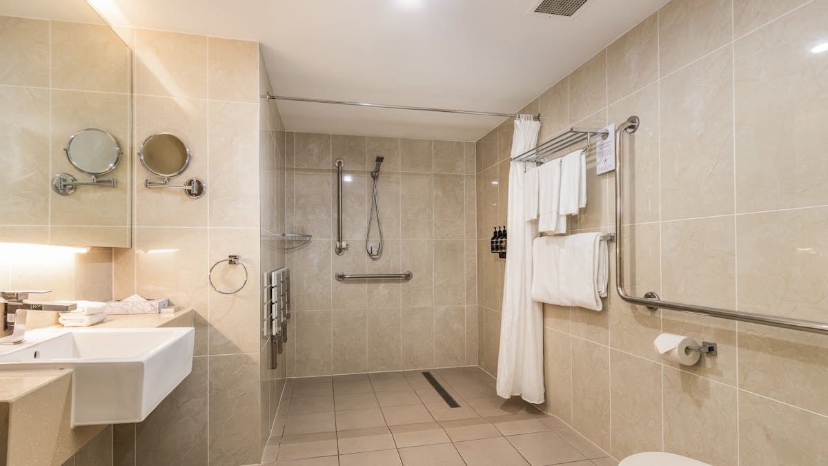 Accessible Bathroom with walk in shower, grab rails in shower and bathroom