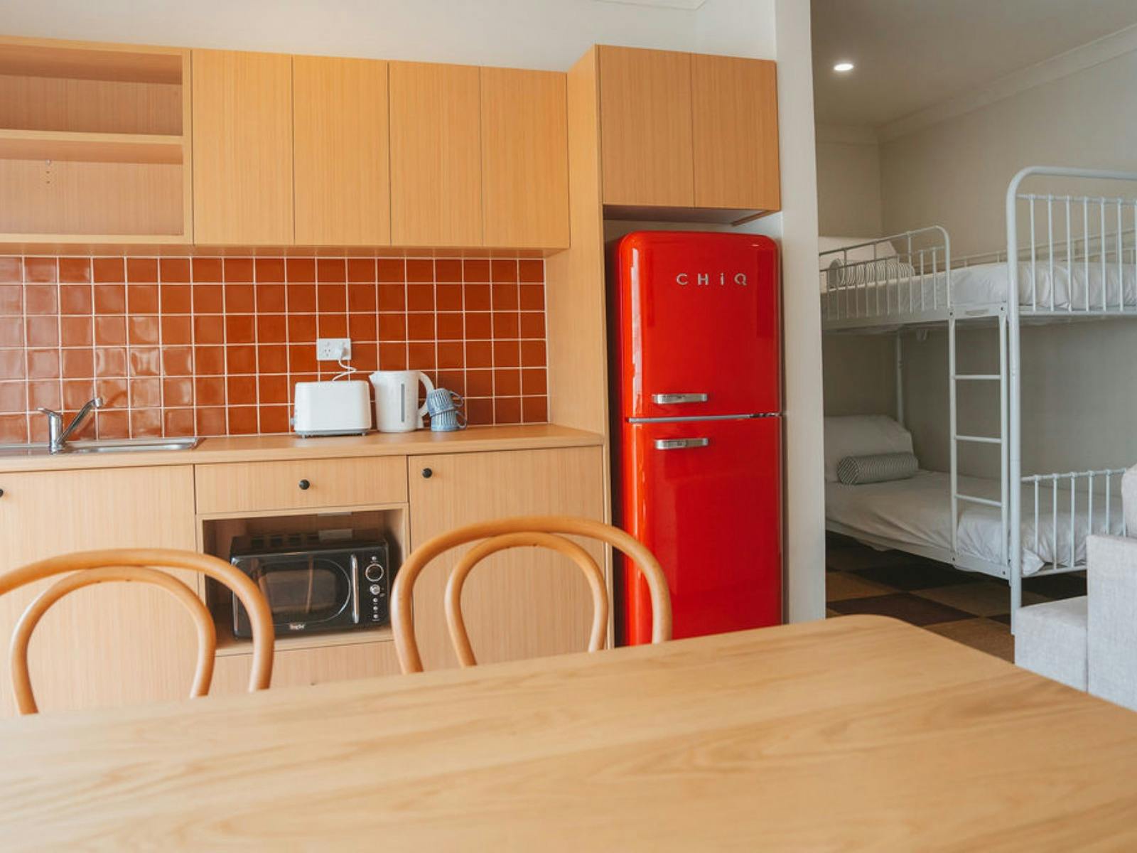 The Palms Suite, a family-friendly suite with kitchenette, retro fridge and bunk beds.