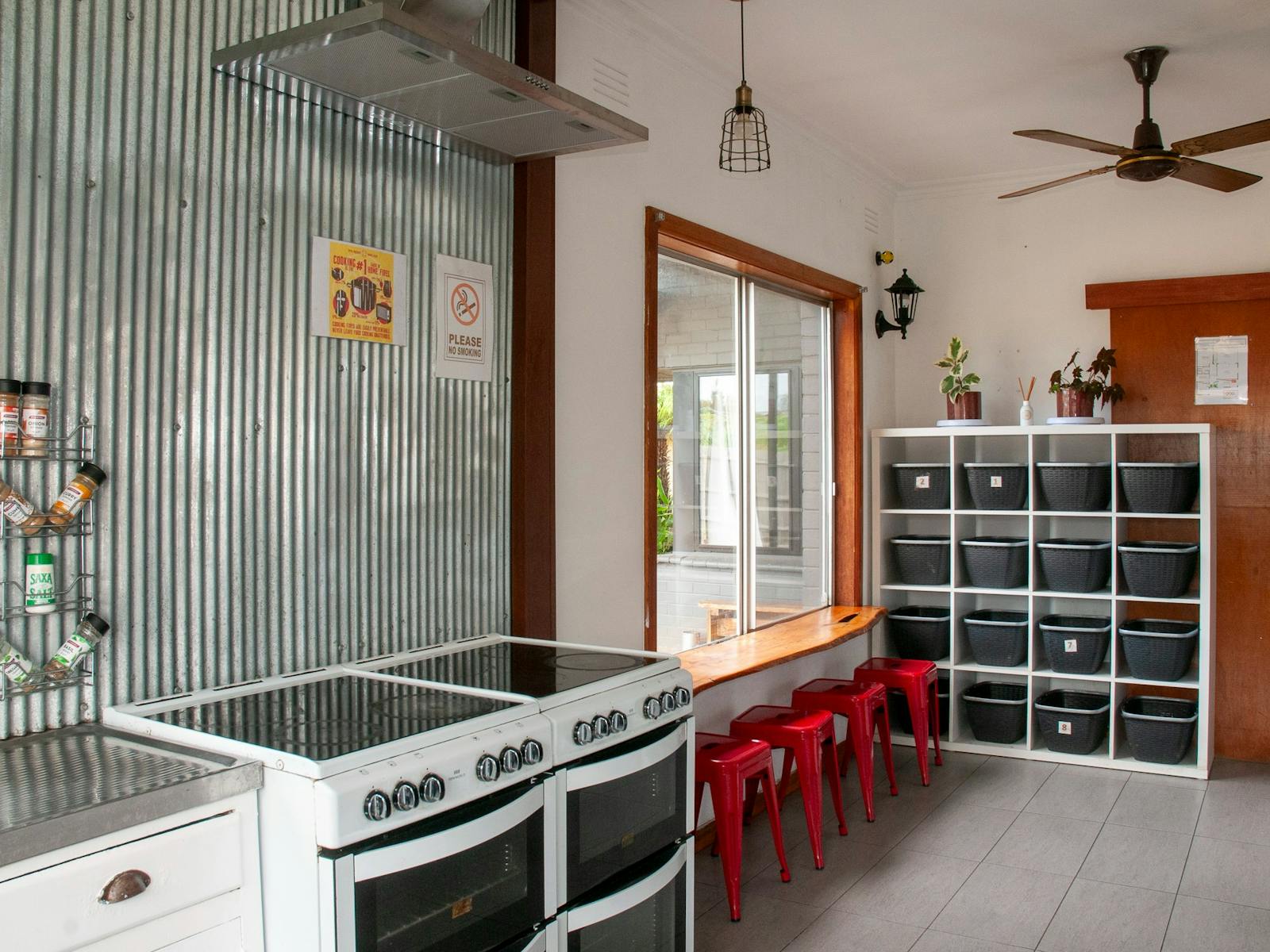 Fully stocked kitchen with large commercial fridge, large freezer, dry storage and breakfast bar