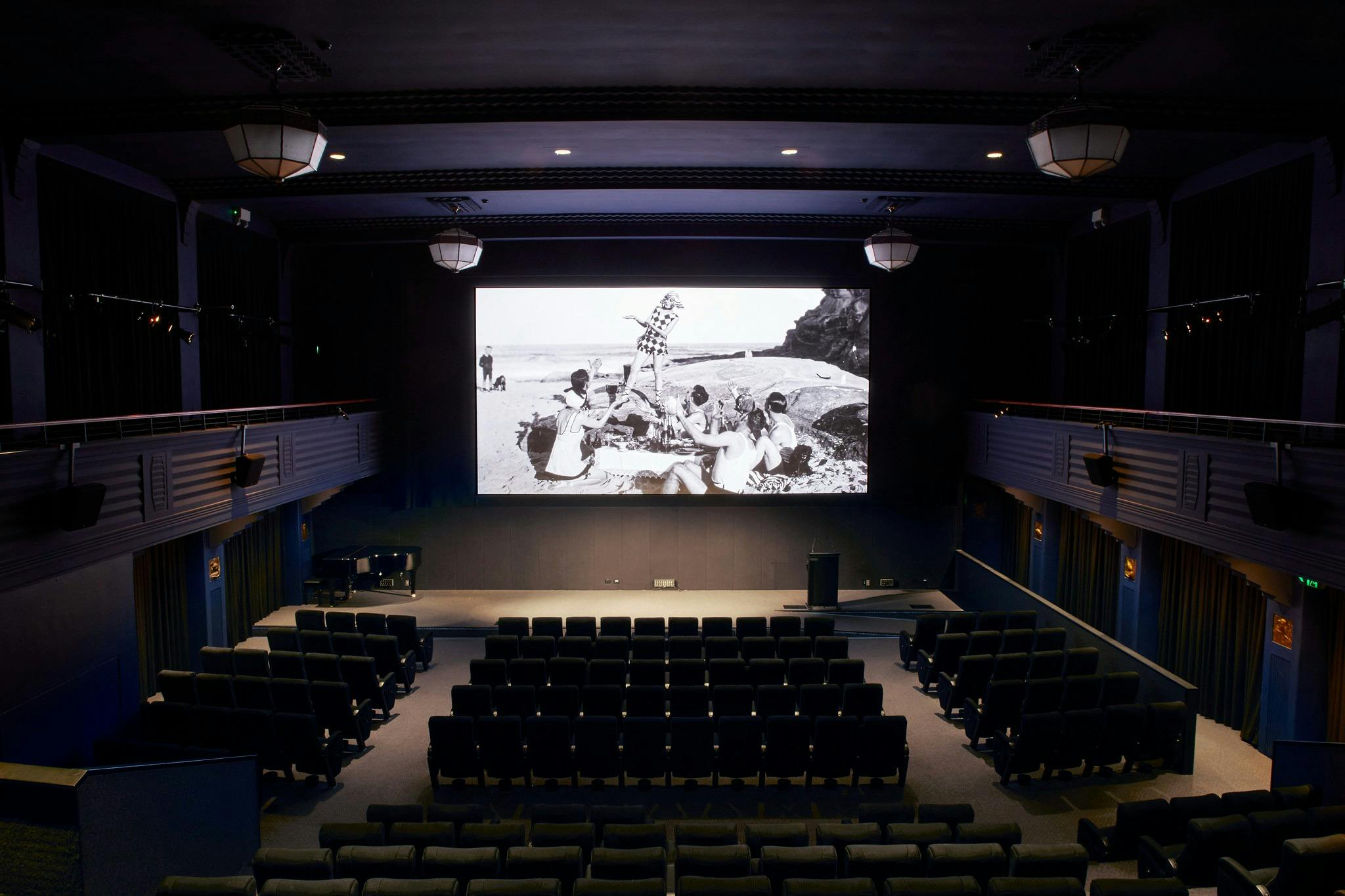 Arc Cinema with archival black and white footage on the screen