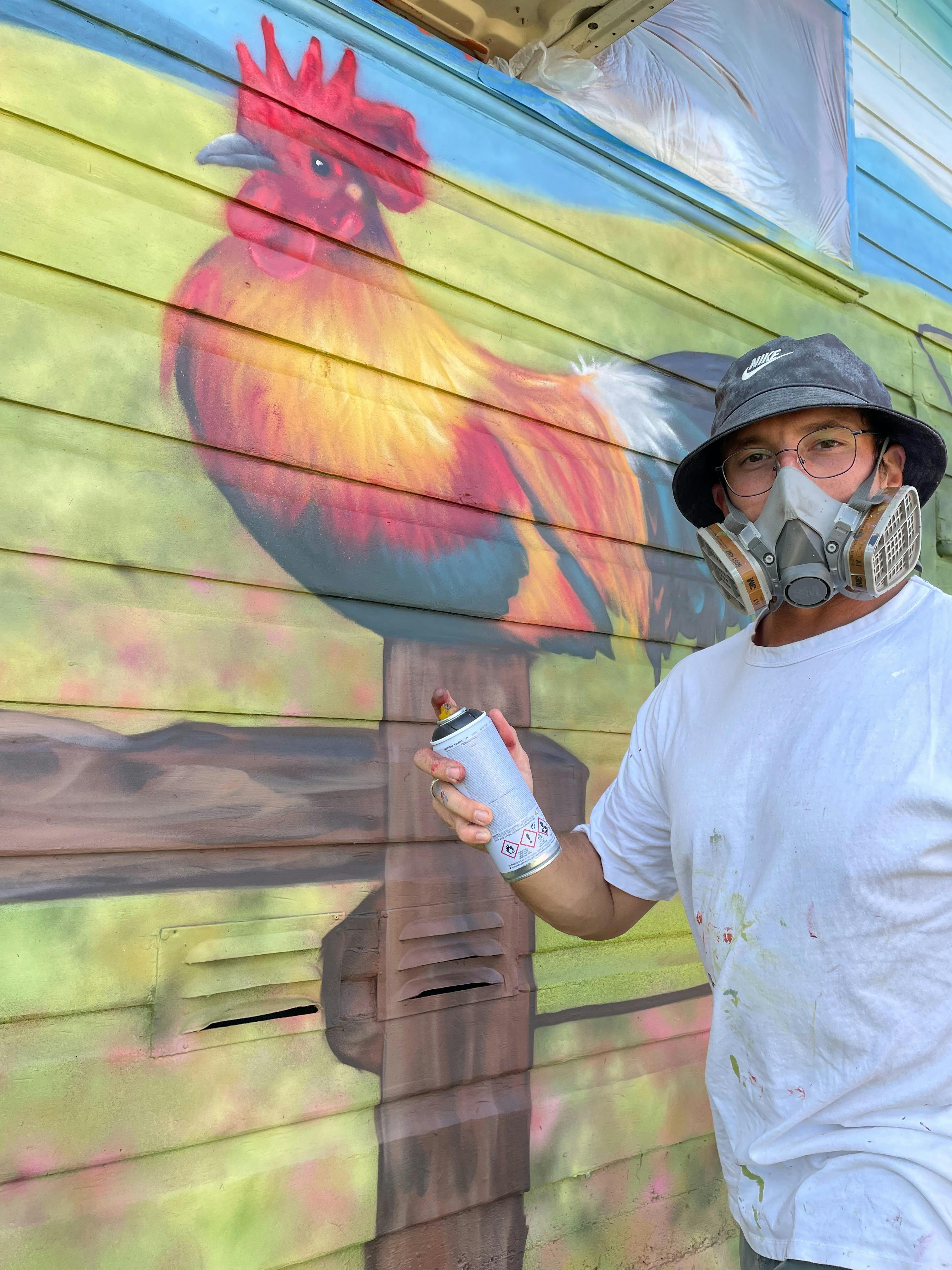 Dan Bianco painting the Gresford Butchers Mural