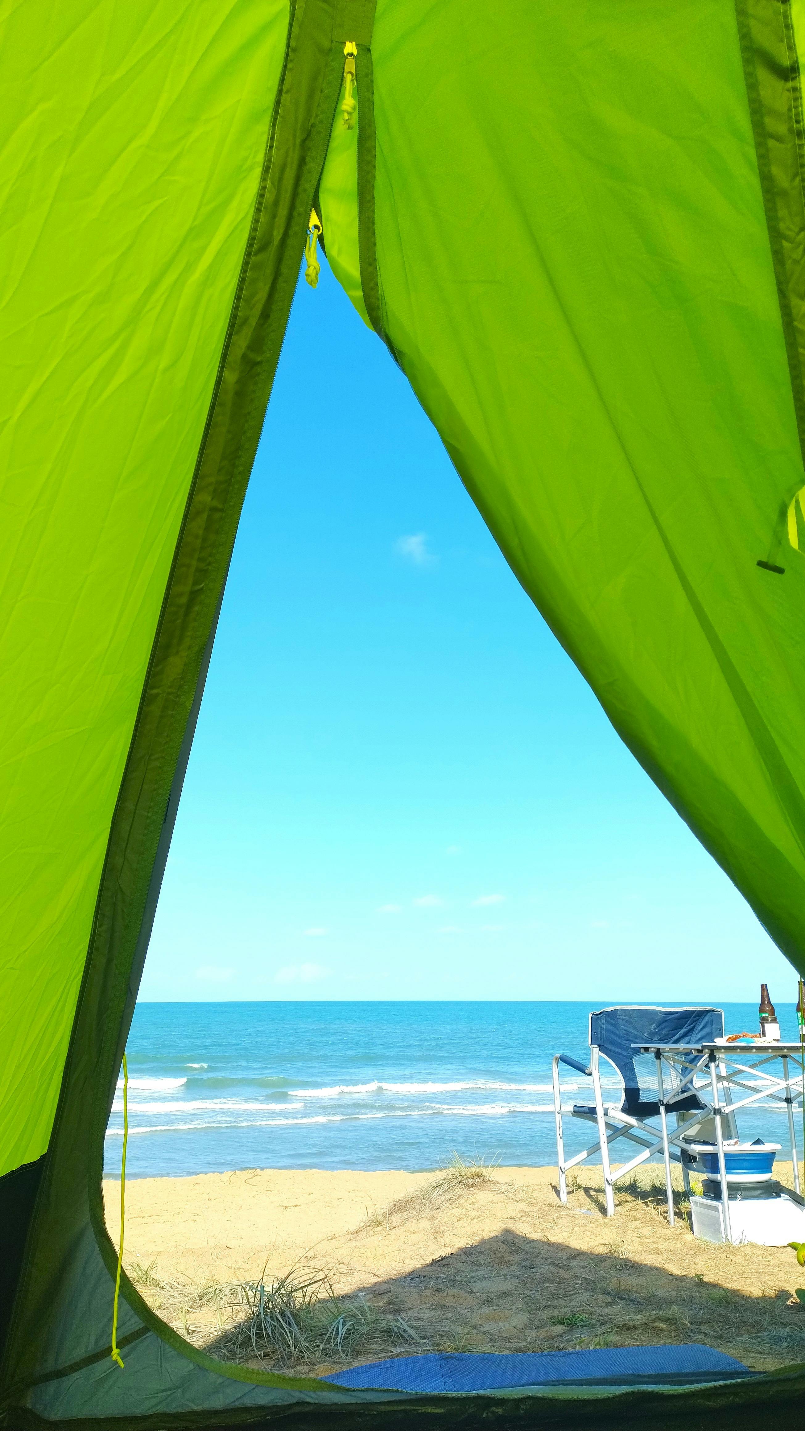 looking out to the ocean from inside a tipi tent