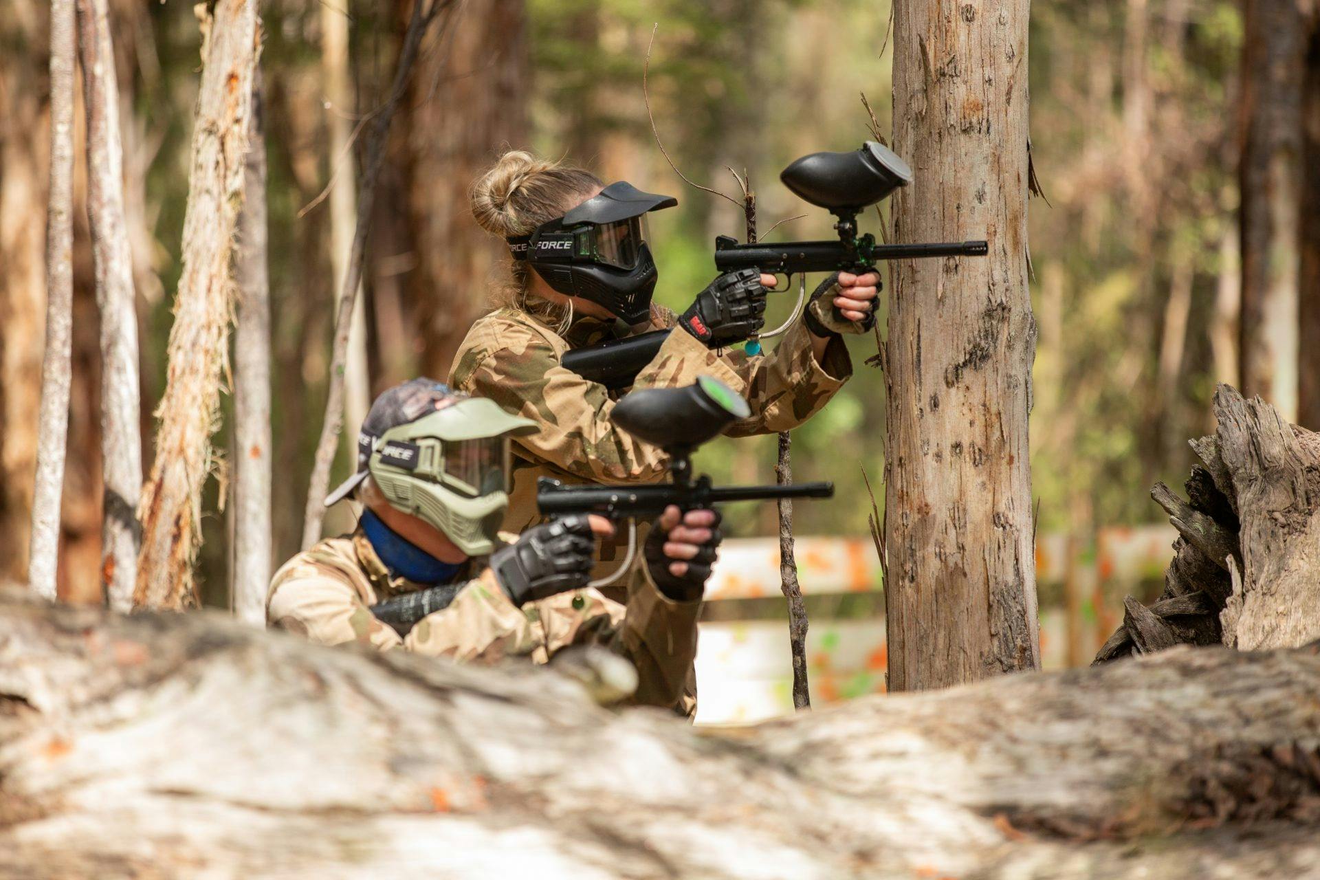 Phoenix Paintball - 2 players using their markers in the bush