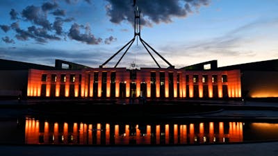 Australian Parliament House at dusk with an orange illumination
