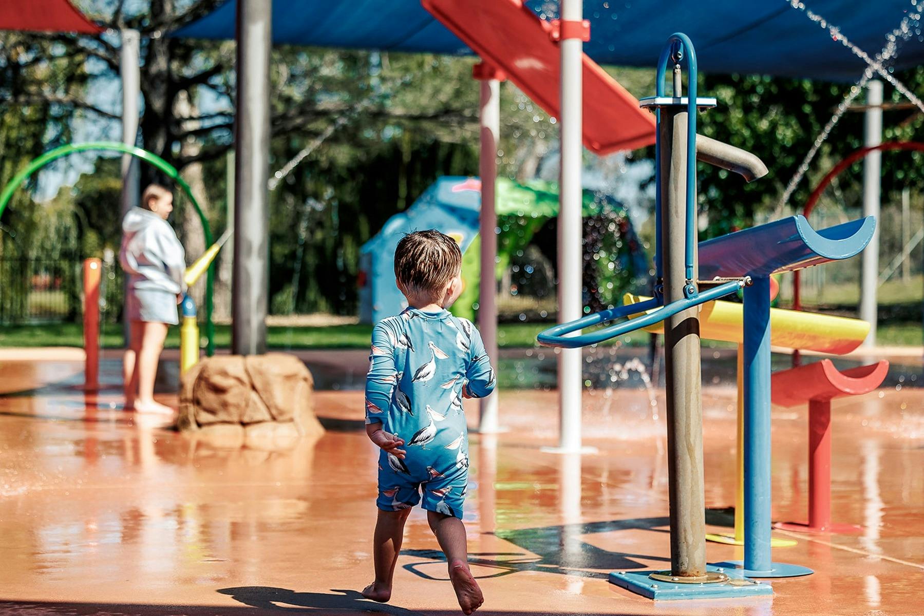 Young boy in blue swimmers at the Benalla Splash Park