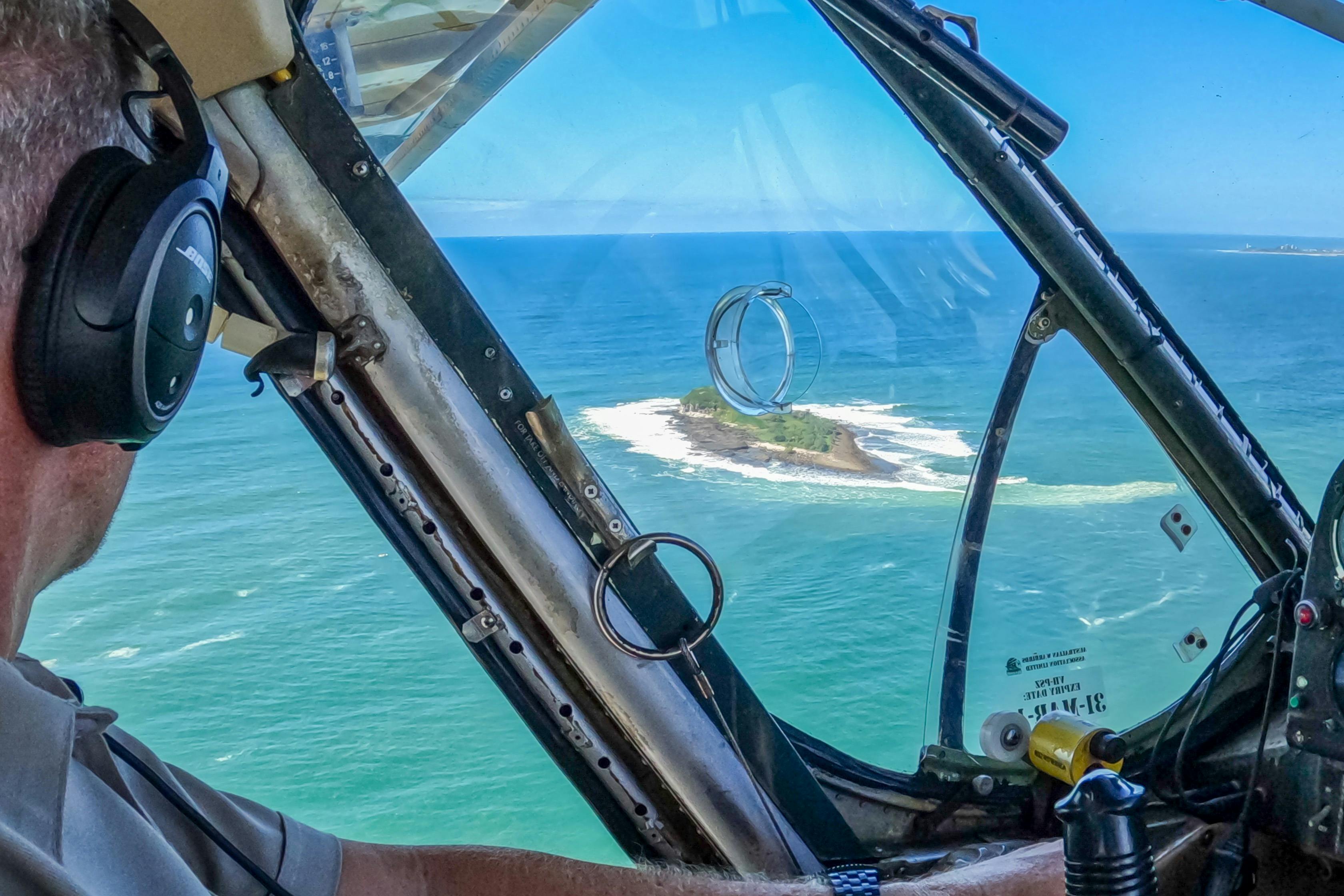 Cockpit view of pilot over ocean and island east of Maroochydore.