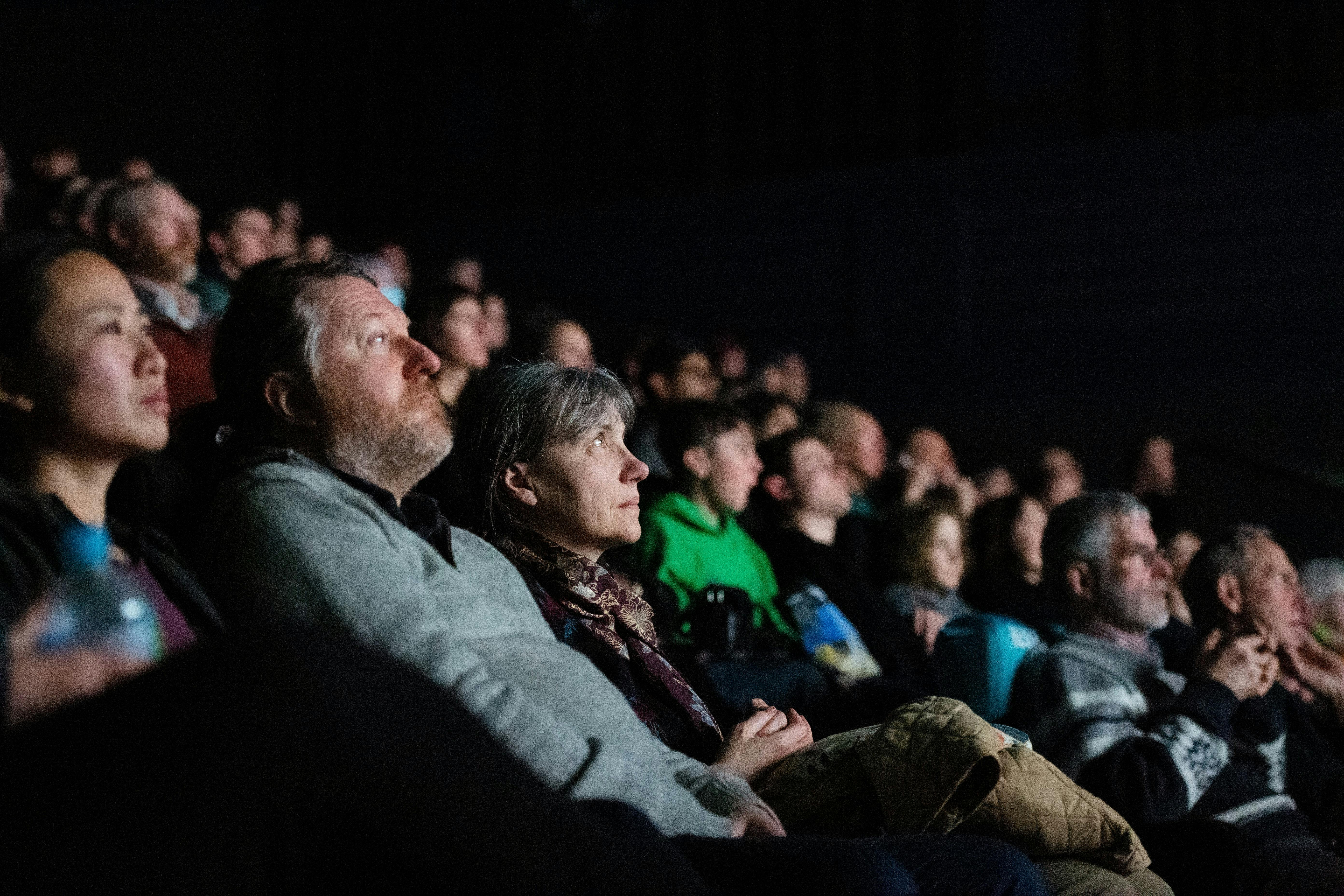 A group of people in a cinema (screen is not visible)