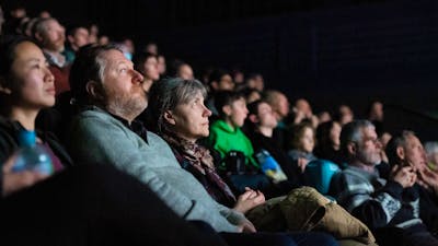 A group of people in a cinema (screen is not visible)