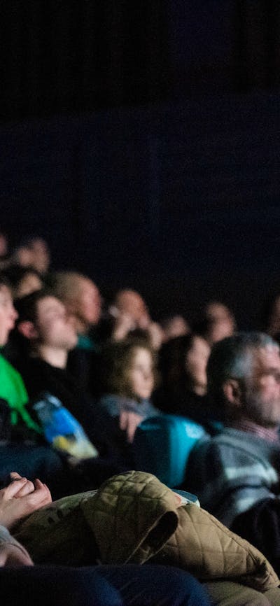 A group of people in a cinema (screen is not visible)
