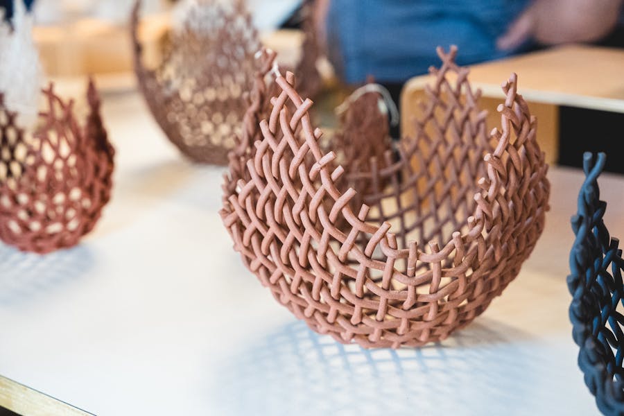 a collection of 3 woven clay baskets