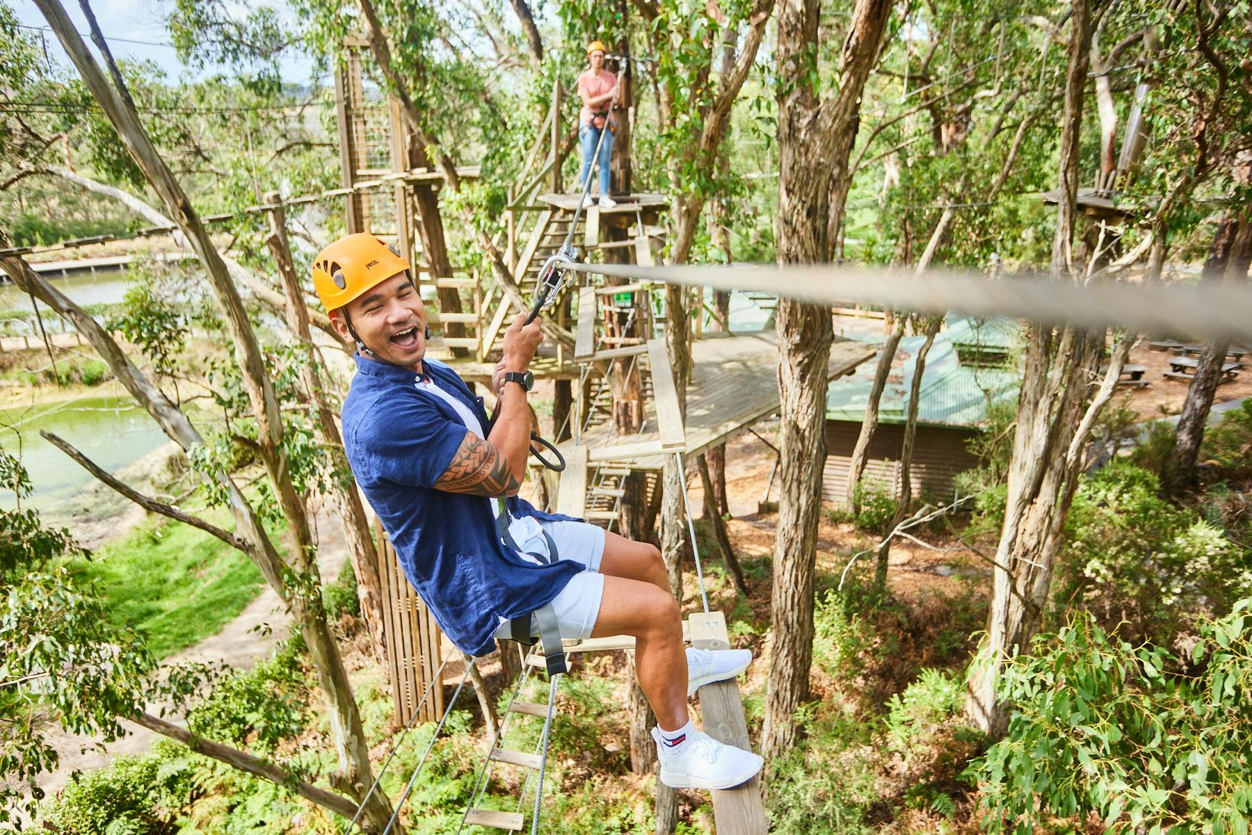 Man and woman on high ropes obstacle course
