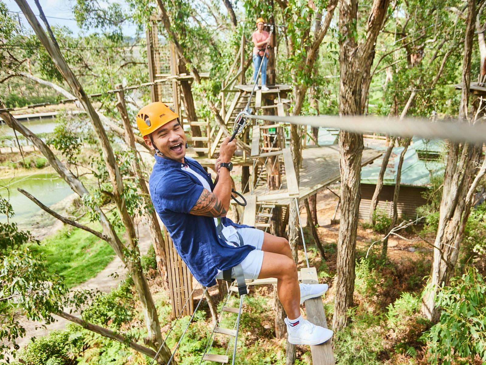 Man and woman on high ropes obstacle course