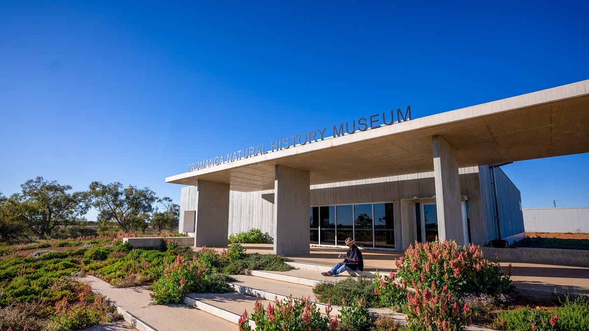 woman sitting on front steps of the museum