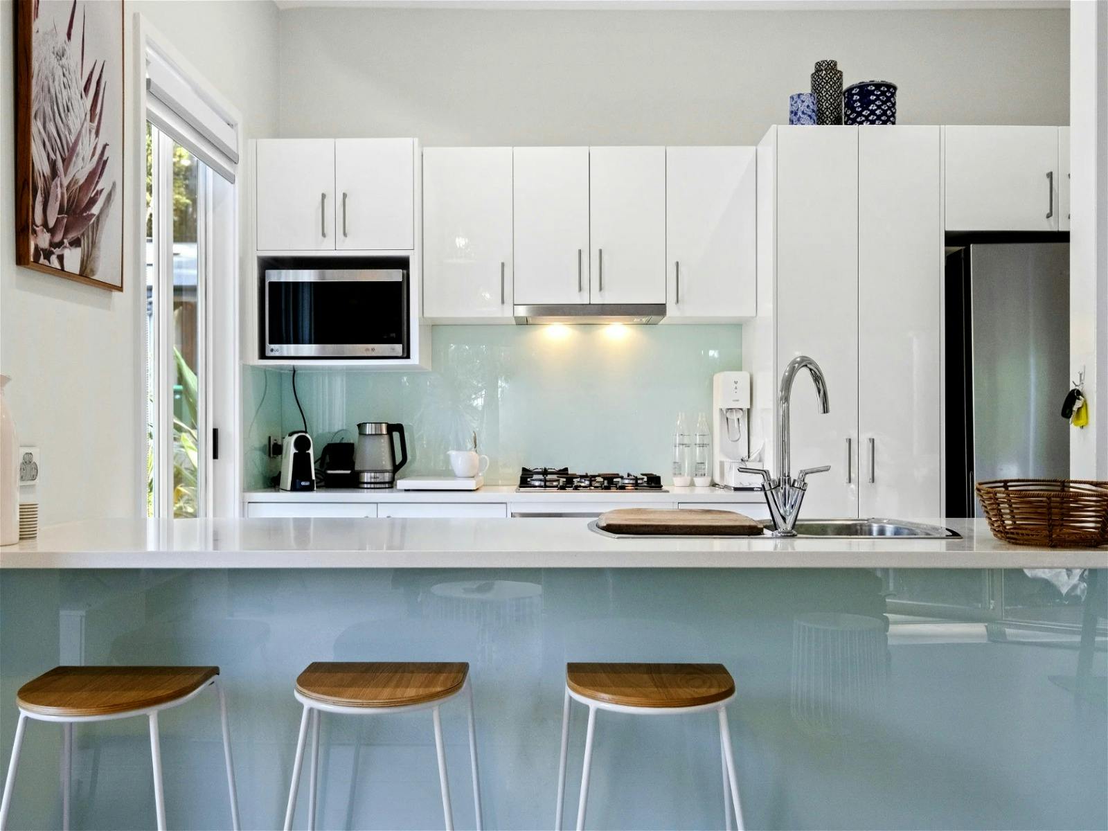 Seperate kitchen area with modern appliances and ample storage