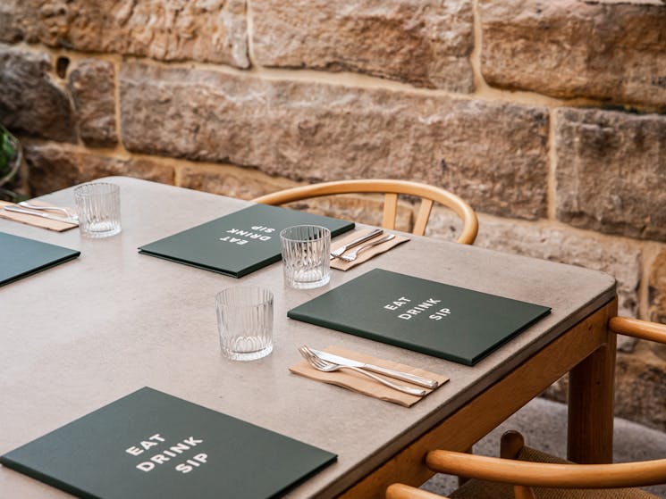 Menus on table with sandstone wall in the background