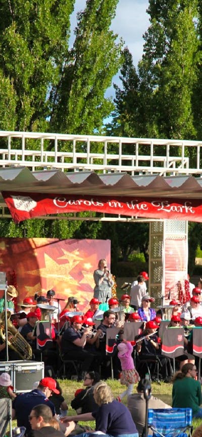 Carollers performing on stage at Carols in Town Park Canberra