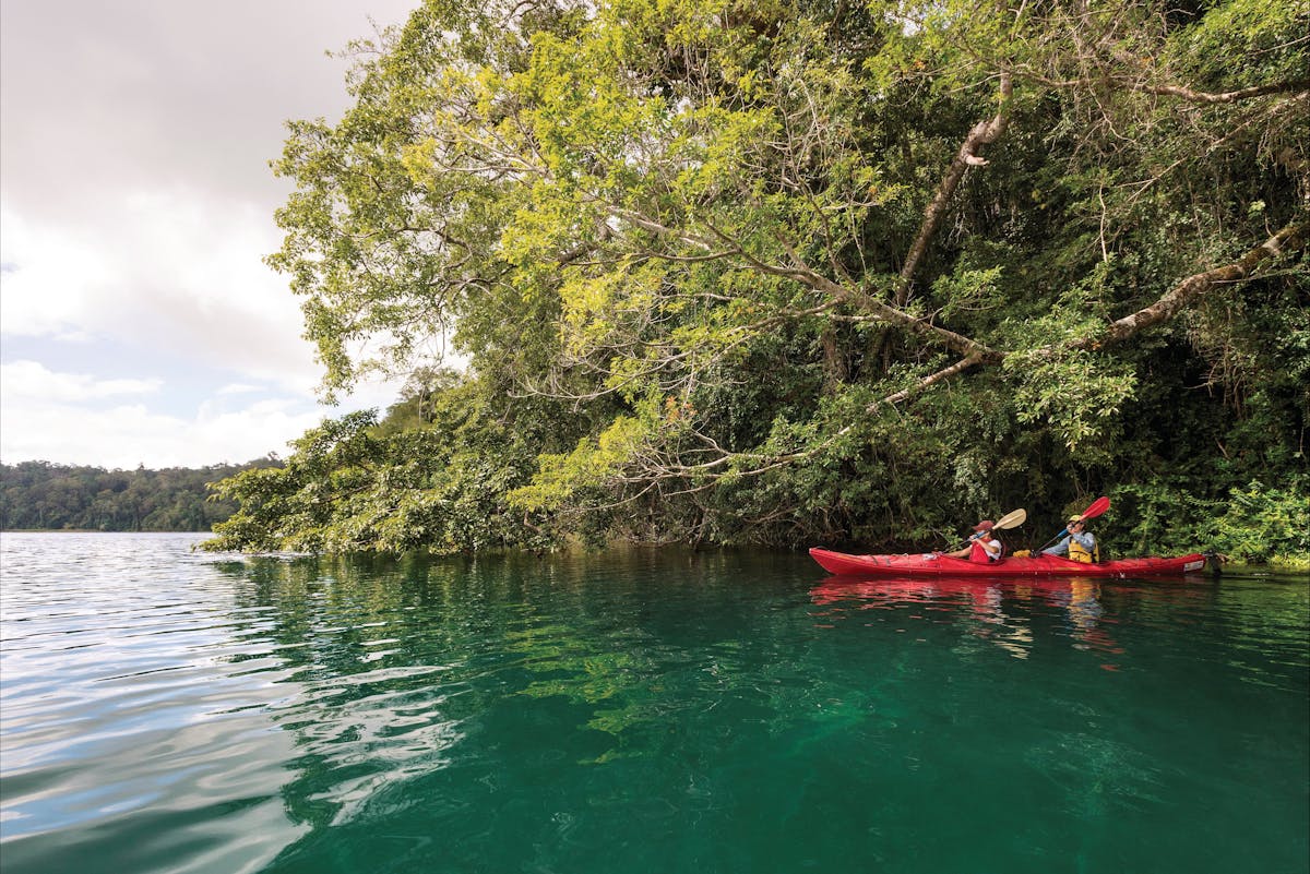 Two kayakers paddling on Lake Barrine