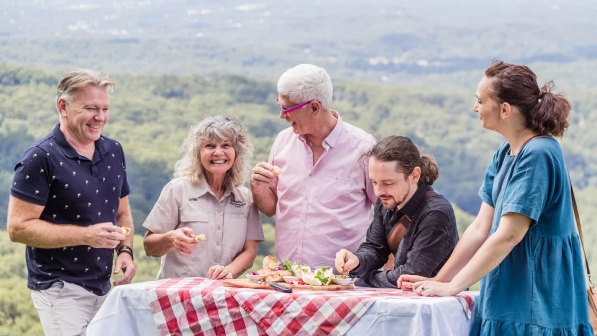 A tour group enjoys a picnic on the Range