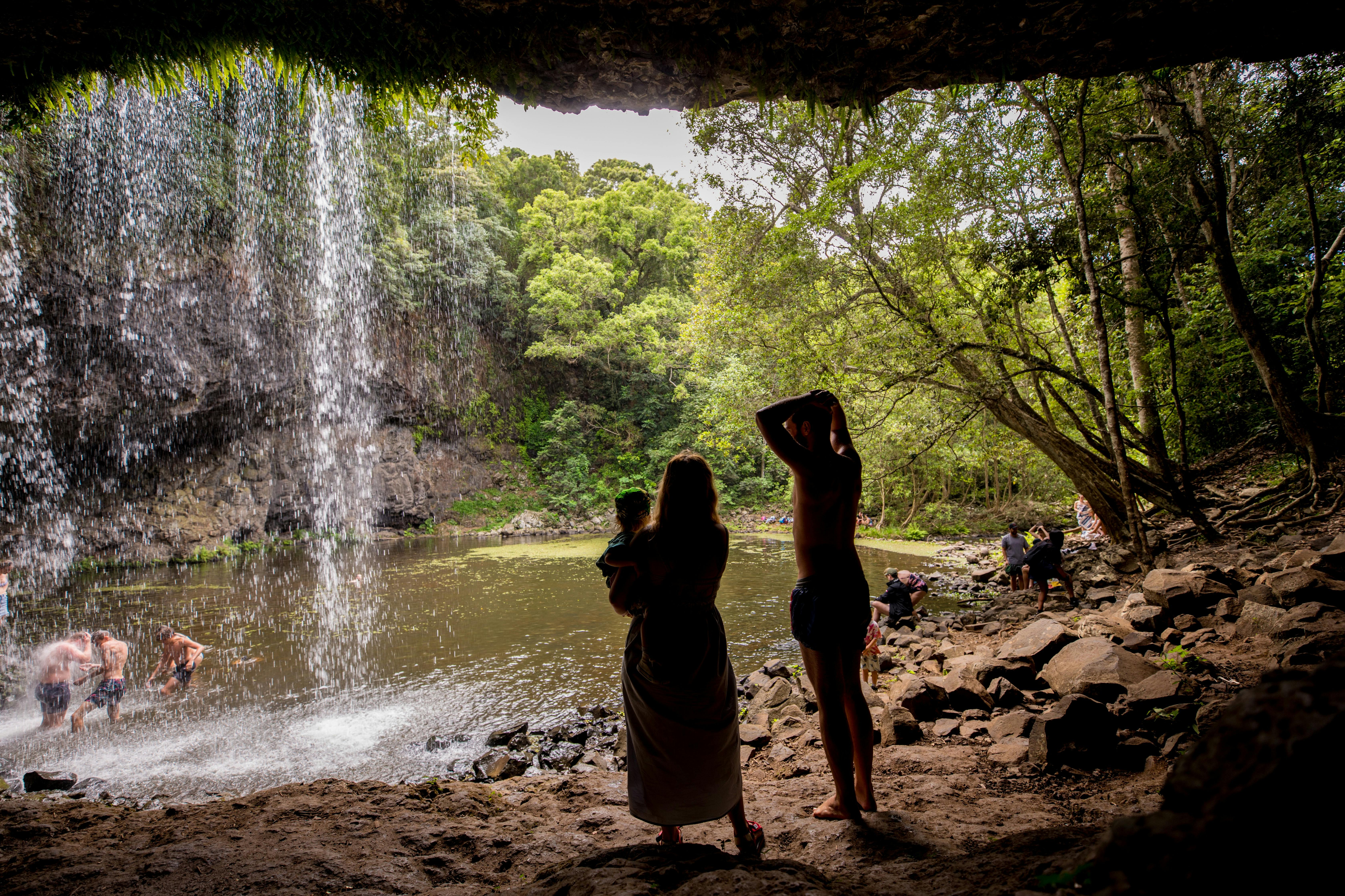 Family enjoys a waterfall in Byron Shire.
