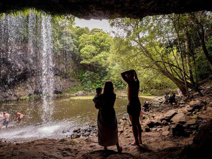 Family enjoys a waterfall in Byron Shire.